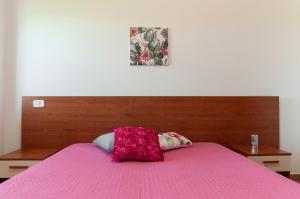 En eller flere senge i et værelse på Villetta Kair 260