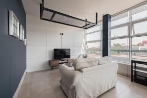 a living room with a couch and a tv at Bed in mixed room Hippie Nice in Mexico City