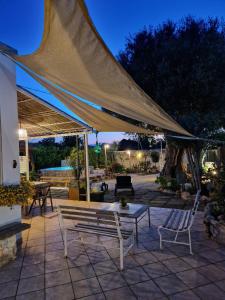 a patio with a tent and chairs and a table at Villa Anna Polignano in Polignano a Mare