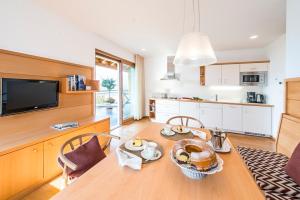 a kitchen with a table with a plate of food on it at Unterpenatz Schenna in Schenna