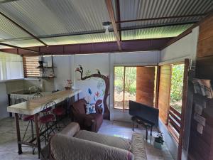 a living room with a couch and a table and a kitchen at Boca Tapada Inn in Boca Tapada