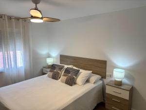 a bedroom with a large bed with white sheets and pillows at Casa Marga By Solymar Holiday in Canillas de Aceituno +40 photos