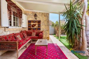 ein Wohnzimmer mit einem roten Sofa und einem Tisch in der Unterkunft Casa Noray del Mar in Castillo del Romeral