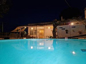 a large swimming pool in front of a house at night at Villa Anna Polignano in Polignano a Mare