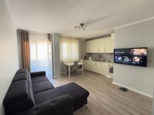 a living room with a couch and a kitchen at Natalia's Apartament in Golem
