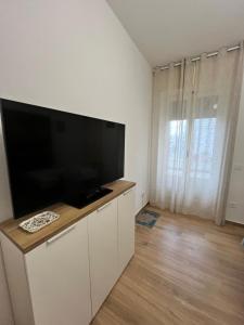 a living room with a large flat screen tv on a cabinet at Gallipoli Dragonfly Inn - Appartamento in Gallipoli