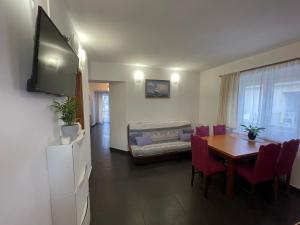 a living room with a dining room table and a couch at Villa Korčula in Vela Luka