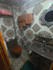 a small bathroom with a toilet and a sink at RIaD DRISSIA Panoramic in Fez +39 photos