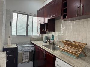 a kitchen with a sink and a counter top at Oasis urbaine in Brazzaville
