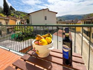 a bowl of fruit and a bottle of wine on a table at La Botte - Original Tuscany Duplex in Compiobbi