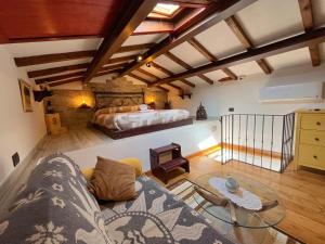 a living room with a couch and a bed at La Botte - Original Tuscany Duplex in Compiobbi