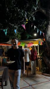 a man walking in front of a food stand at night at El Sofá Caracas in Caracas
