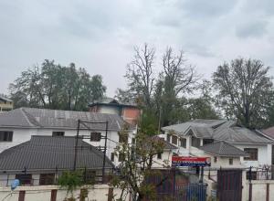 a group of houses with roofs and trees at Shahdaar inn in Srinagar