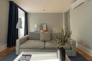 a living room with a couch and a table at Esqina Urban Lodge in Lisbon