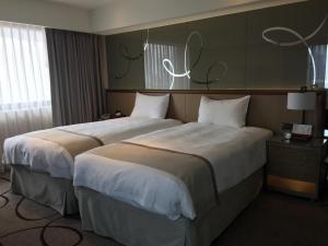 Postel nebo postele na pokoji v ubytování Kaohsiung Chateau de Chine Hotel
