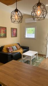 a living room with a couch and a table at La Loubière - le gîte au cœur de la nature in Combret