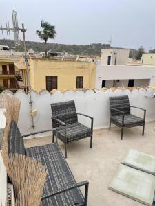 two chairs and a table on top of a roof at nanzi u mare in San Vito lo Capo
