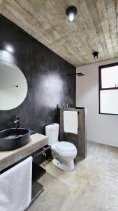 a bathroom with a toilet and a sink at Aldea Paraíso - Adults only - Boutique hotel in Puerto Escondido +60 photos