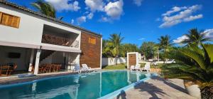 a villa with a swimming pool and a house at Cânions Hotel in Olho D’Água do Casado