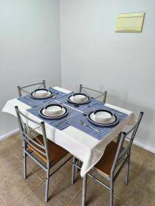 a table with chairs and a blue and white table cloth at Departamento Corcovado in Puerto Montt