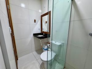 a bathroom with a toilet and a glass shower at Pousada du Vento in Cruz +17 photos