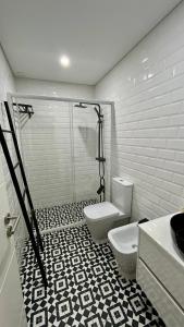 a bathroom with a shower and a toilet in it at Casa Berlenga in Peniche +14 photos