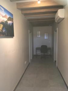 a hallway with a desk and a painting on the wall at air de campagne in Saint-Loubouer
