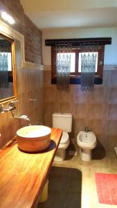 a bathroom with a sink and a toilet at PiedrasBlancas in Mar de las Pampas +15 photos
