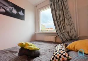 a stuffed animal sitting on a bed in a bedroom at Turtle Room - 3 km to Baltic Sea in Gdańsk