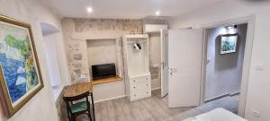 a small room with a kitchen and a tv in it at Lorenzo Old Town in Dubrovnik