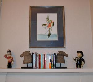 a shelf with books and figurines on top of it at Maybank Guest House in Helensburgh
