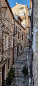 an old stone alley with stairs in an old building at Lorenzo Old Town in Dubrovnik
