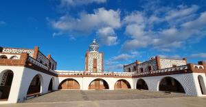 a building with a clock tower on top of it at Lagarto Playas Majoreras in Las Playitas