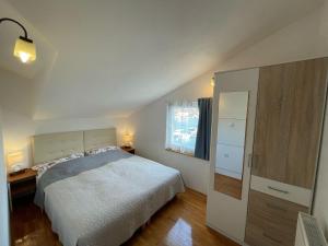 a bedroom with a white bed and a window at Villa Korčula in Vela Luka