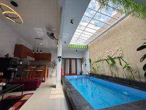 a swimming pool in the middle of a house at Erindra Villa in Pesanggaran