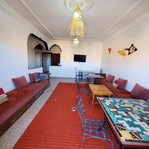 a living room with a couch and a table at WARZAZAT Hostel in Ouarzazate +31 photos