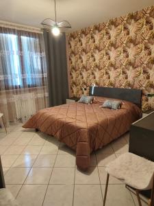 a bedroom with a large bed with a brown blanket at Casa di Elena in Mottella