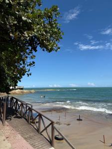a beach with people swimming in the ocean at Suites Prime in Marataizes