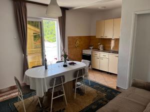 a kitchen with a table with a white table cloth at Apartmani podaca in Podaca