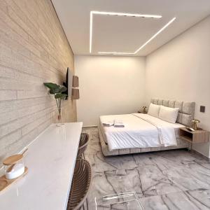 a bedroom with a bed and a stone wall at Foret Lofts in Medellín
