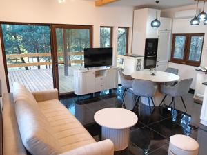 a living room with a couch and a table and chairs at Osada Blanka Black & White Swornegacie in Swornegacie 