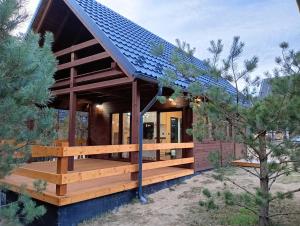 a house with a solar roof on a deck at Osada Blanka Black & White Swornegacie in Swornegacie 