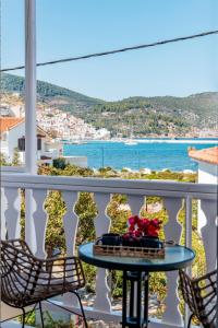 a table on a balcony with a view of the ocean at Fotis Studios in Skopelos Town +119 photos