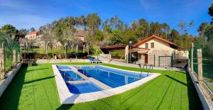 a swimming pool in the yard of a house at Casa Iria in Lousame