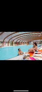 two pictures of people sitting in a swimming pool at Mobilhome in Litteau