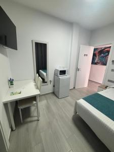Postel nebo postele na pokoji v ubytování Hostal Los Mellizos