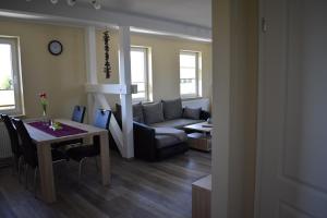 a living room with a table and a couch at Große Wohnung in Roggentin