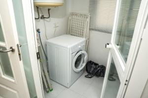 eine Waschmaschine und ein Trockner in einem kleinen Raum in der Unterkunft Sea view apartment with great terrace and 4 pools - Duquesa Suites 430 in Manilva