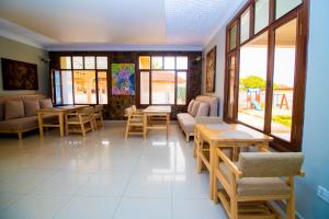 キガリにあるArthillsBoutiqueHotelのテーブルと椅子、窓のある待合室