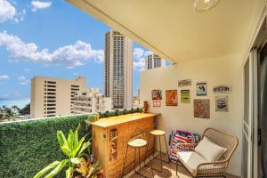 a balcony with a bar and a view of the city at Surf & Sip Ocean View Tiki Style in Honolulu
